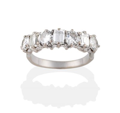 Lot 140 - A Diamond Seven Stone Ring, four round brilliant cut diamonds alternate with three baguette cut...