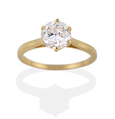 Lot 142 - A Diamond Solitaire Ring, a round cut diamond in six yellow claws, on a tapered shoulder plain...