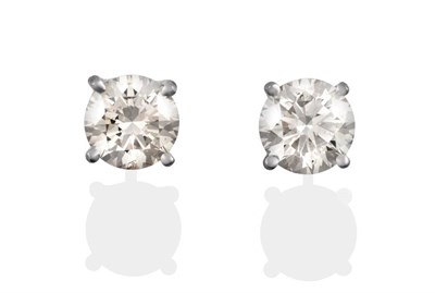 Lot 145 - A Pair of Diamond Solitaire Earrings, the round brilliant cut diamonds in white four claw settings
