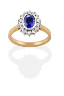 Lot 147 - An 18 Carat Gold Sapphire and Diamond Cluster Ring, the oval mixed cut sapphire in a white...