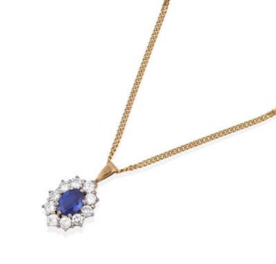 Lot 152 - A Sapphire and Diamond Cluster Pendant, an oval cut sapphire within a border of round brilliant cut