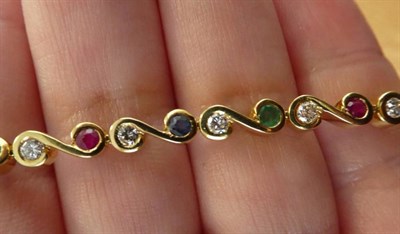 Lot 158 - An 18 Carat Gold Diamond, Ruby, Sapphire and Emerald Bracelet, the round brilliant cut diamonds and