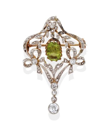 Lot 161 - An Edwardian Diamond and Peridot Brooch, the oval cut peridot in yellow claws suspended within...