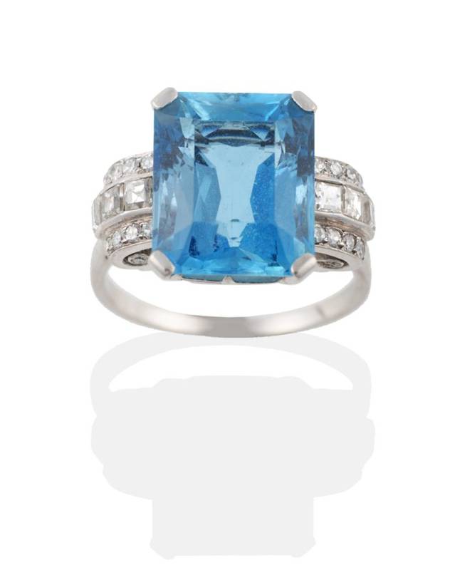 Lot 168 - ^ An Aquamarine and Diamond Ring, an octagonal cut aquamarine in a claw setting, to eight-cut...