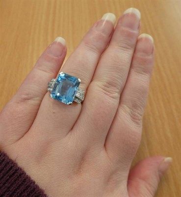 Lot 168 - ^ An Aquamarine and Diamond Ring, an octagonal cut aquamarine in a claw setting, to eight-cut...