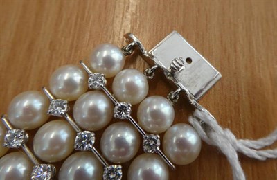 Lot 171 - ^ A Cultured Pearl and Diamond Bracelet, four rows of uniform cultured pearls, each spaced by round