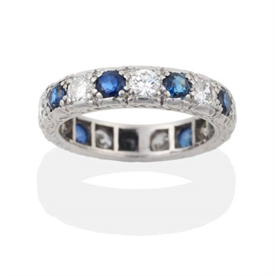 Lot 177 - A Sapphire and Diamond Eternity Ring, nine round brilliant cut diamonds alternate with round...