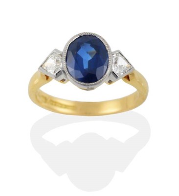 Lot 189 - An 18 Carat Gold Sapphire and Diamond Three Stone Ring, the oval mixed cut sapphire in a white...