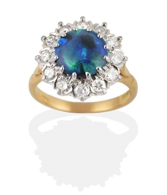 Lot 191 - An 18 Carat Gold Black Opal and Diamond Cluster Ring, the polished round black opal within a border