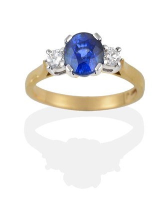 Lot 192 - An 18 Carat Gold Sapphire and Diamond Three Stone Ring, the oval mixed cut sapphire between two...