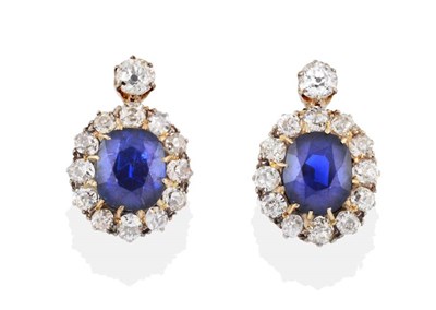 Lot 194 - ^ A Pair of Sapphire and Diamond Cluster Earrings, an old cut diamond in a white claw setting...