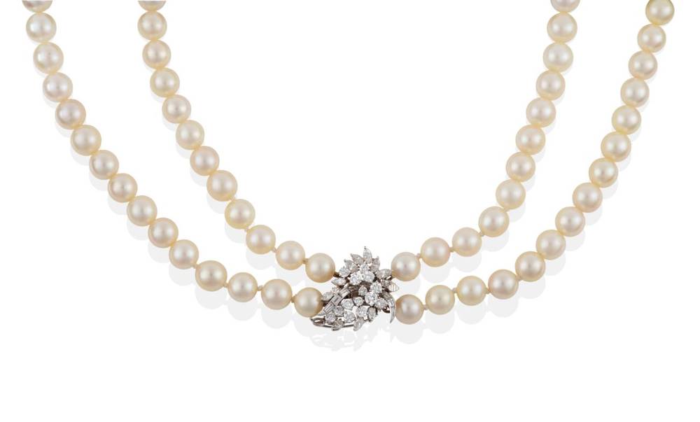 Lot 195 - ^ A Double Strand Cultured Pearl Necklace, with a Diamond Clasp, uniform cultured pearls knotted to