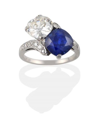 Lot 197 - A Sapphire and Diamond Crossover Ring, the old cut diamond and cushion cut sapphire, in white...