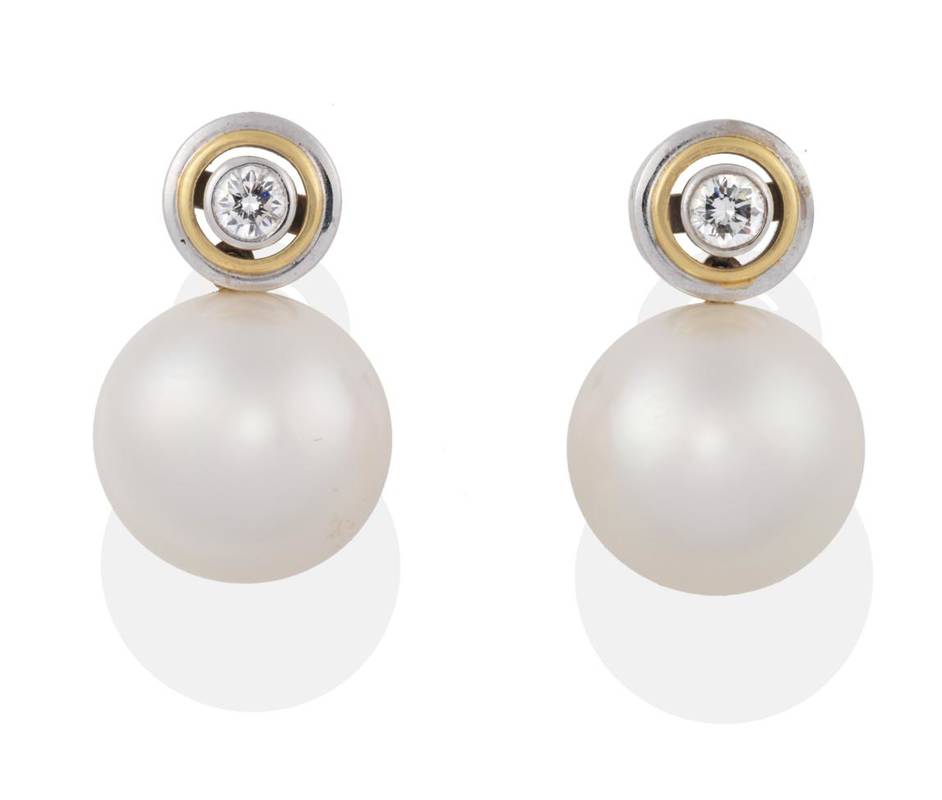 Lot 202 - ^ A Pair of Cultured South Sea Pearl and Diamond Earrings, a round brilliant cut diamond in a...
