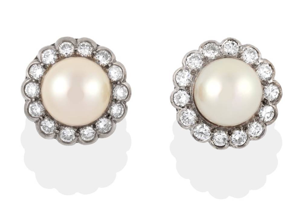 Lot 204 - ^ A Pair of Cultured Pearl and Diamond Cluster Earrings, a cultured pearl within a border of...