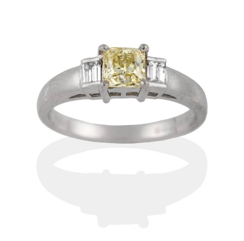 Lot 205 - A Platinum Diamond Three Stone Ring, the yellow princess cut diamond in a four claw setting to...