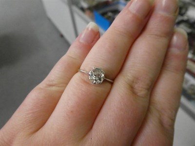 Lot 221 - A Diamond Solitaire Ring, the old cut diamond in a white claw setting, to white fronted...