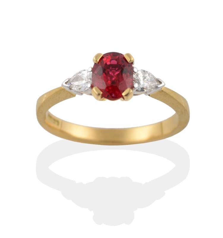 Lot 230 - An 18 Carat Gold Red Spinel and Diamond Three Stone Ring, the oval mixed cut spinel in a yellow...