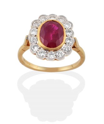 Lot 231 - An 18 Carat Gold Ruby and Diamond Cluster Ring, the oval mixed cut ruby in a yellow rubbed over...