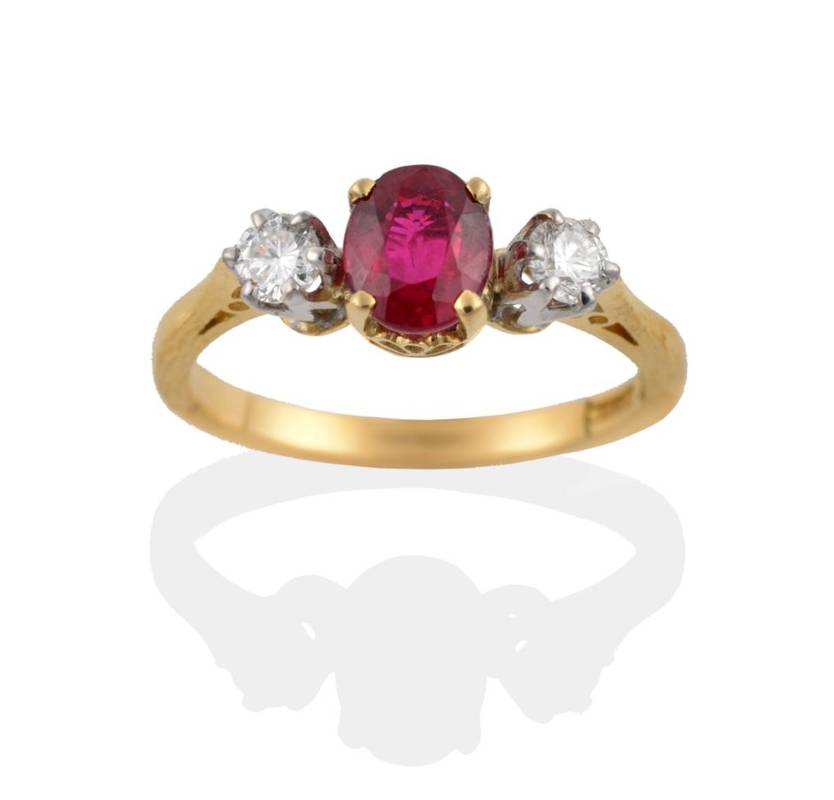 Lot 232 - An 18 Carat Gold Ruby and Diamond Three Stone Ring, the oval mixed cut ruby in four yellow...
