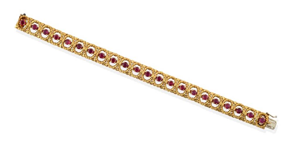 Lot 233 - ^ An 18 Carat Gold Ruby Bracelet, round cut rubies in claw settings within oval rope frames, length