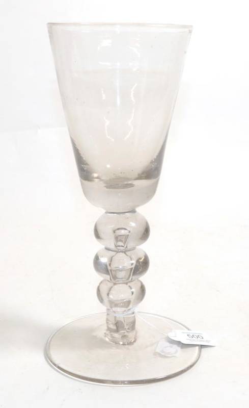 Lot 500 - A Baluster Glass Goblet, circa 1740, the rounded funnel bowl on a triple knopped stem with air tear