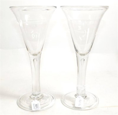 Lot 501 - ~ A Pair of Glass Goblets, mid-18th century, the conical bowls on plain stems with air tears,...