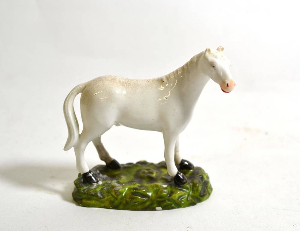 Lot 517 - A Derby Porcelain Model of a Horse, circa 1820, naturalistically modelled standing four square on a