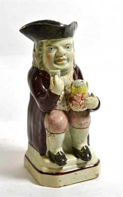 Lot 520 - A Pearlware Miniature Toby Jug, circa 1800, traditionally modelled seated wearing a tricorn hat and
