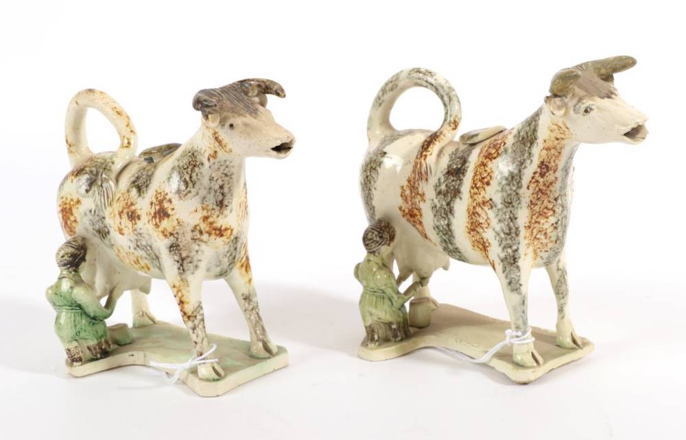 Lot 524 - A Creamware Cow Creamer and Stopper, circa 1820, the standing beast with green and ochre...