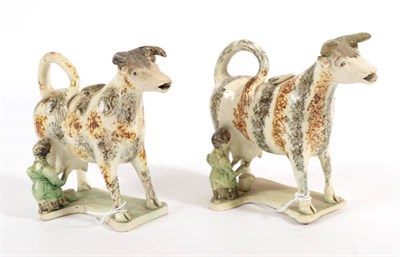 Lot 524 - A Creamware Cow Creamer and Stopper, circa 1820, the standing beast with green and ochre...