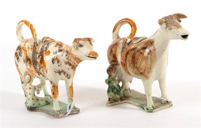 Lot 525 - A Creamware Cow Creamer and Stopper, circa 1820, the standing beast with brown and ochre...