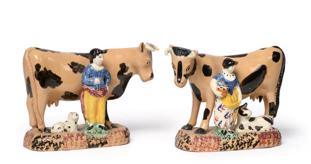 Lot 530 - A Pair of Yorkshire Pratt Type Pottery Cow Groups, circa 1810, the standing beasts with buff...