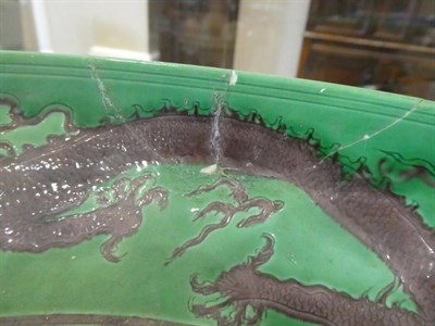 Lot 552 - A Chinese Porcelain Green Ground Aubergine Dragon Dish, Kangxi reign mark and of the period,...
