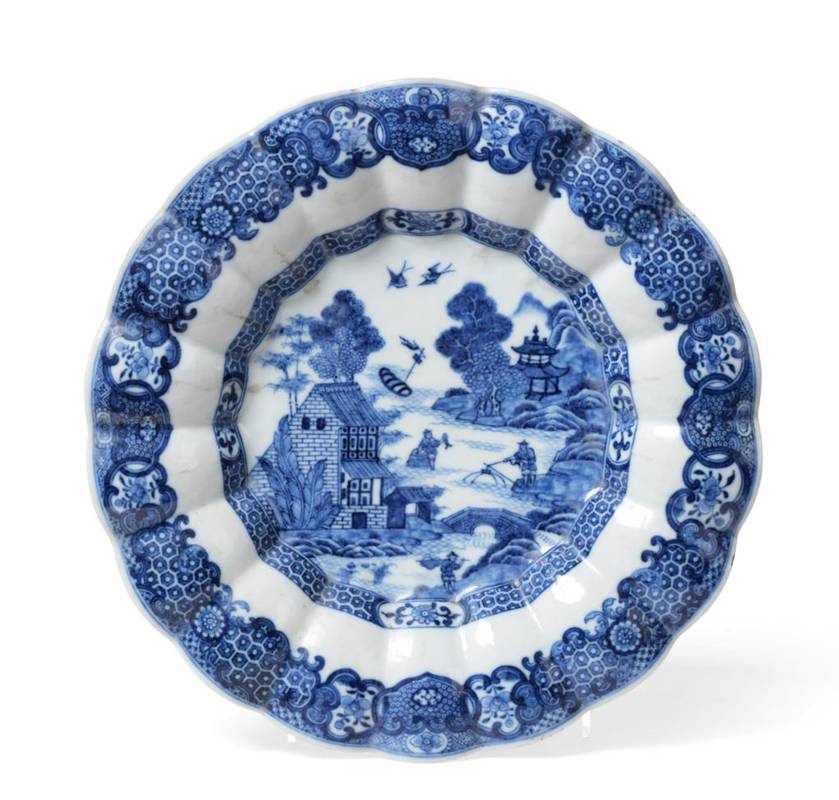 Lot 558 - A Chinese Porcelain Dish, Qianlong, of fluted circular form, painted in underglaze blue with a...
