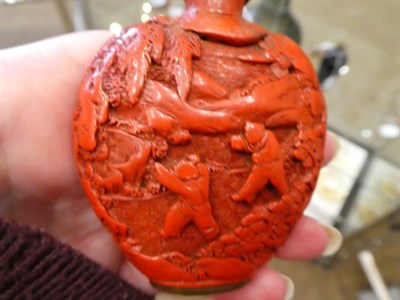 Lot 567 - A Chinese Cinnabar Lacquer Snuff Bottle and Stopper, probably Suzhou, 1740-1800, of flattened ovoid