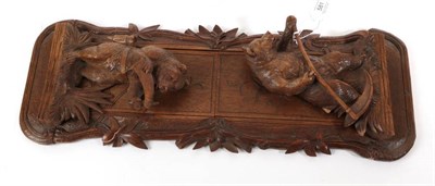 Lot 581 - ~ A Black Forest Carved Wood Book Trough, late 19th century, with bear bookends, 53cm wide
