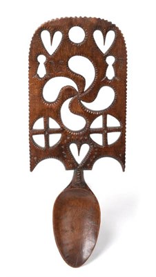 Lot 582 - A Welsh Fruitwood Love Spoon, mid 19th century, the broad stem carved and pierced with hearts,...