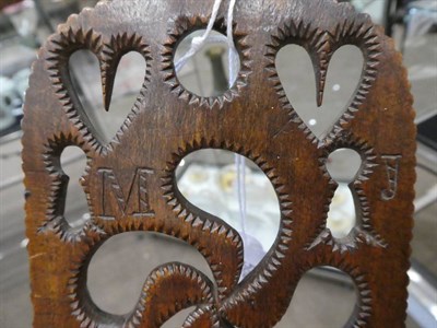 Lot 582 - A Welsh Fruitwood Love Spoon, mid 19th century, the broad stem carved and pierced with hearts,...
