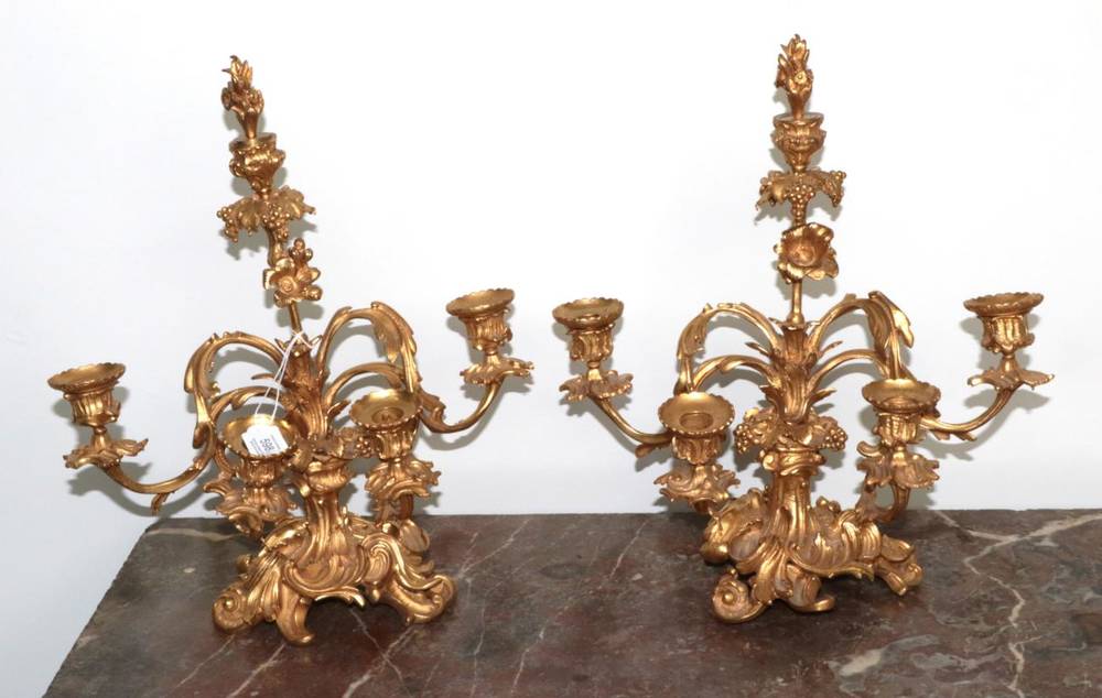 Lot 598 - ~ A Pair of French Gilt Bronze Four-Light Candelabra, in Rococo style, the urn shaped sconces...