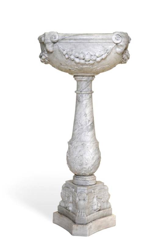 Lot 621 - A Grey Veined White Marble Font, 17th century, the circular bowl carved with ram's mask hung...