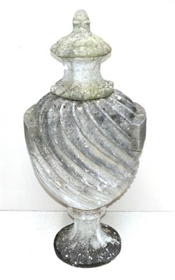 Lot 623 - ~ A Carved Stone Urn, in 18th century style, with foliate finial, wrythen fluted ovoid body...