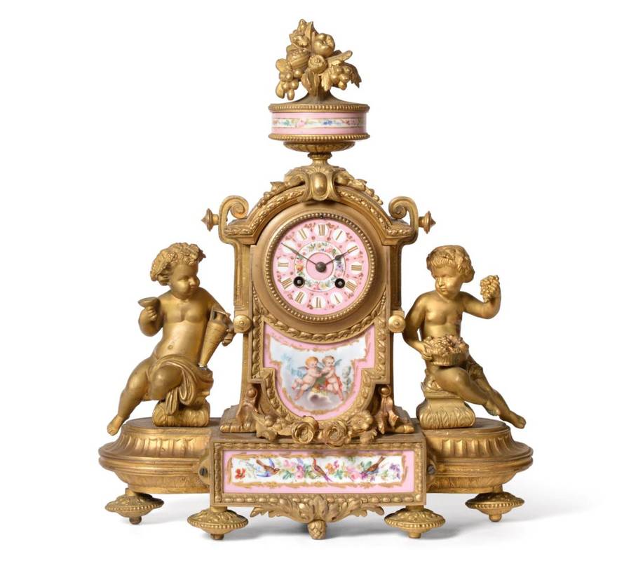 Lot 632 - ~ A Gilt Metal Porcelain Striking Mantel Clock, circa 1890, urn finial, pink ground porcelain front
