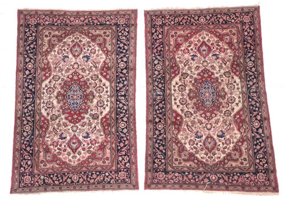 Lot 646 - ^ Pair of Isfahan Rugs Central Iran, circa 1920 Each with a cream field of vines around a raspberry