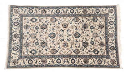 Lot 654 - Kashan Rug Central Iran, circa 1960 The ivory field with an allover design of palmettes, vines...