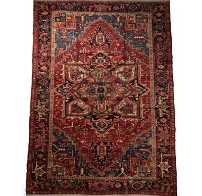 Lot 658 - Heriz Carpet Iranian Azerbaijan, circa 1910 The terracotta field of angular vines centred by a...