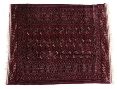Lot 665 - Tekke Rug  Emirate of Bukhara, 1910 The claret field with three columns of typical quartered...