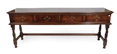 Lot 670 - An 18th Century Oak Low Dresser, the moulded top with four crossbanded frieze drawers, on...
