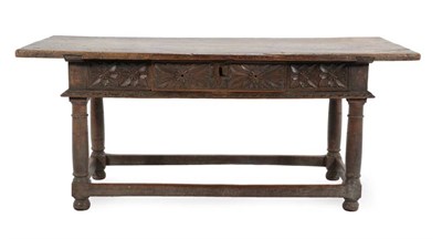 Lot 676 - A Mid 17th Century Refectory Table, the rectangular top above a frieze drawer carved with...
