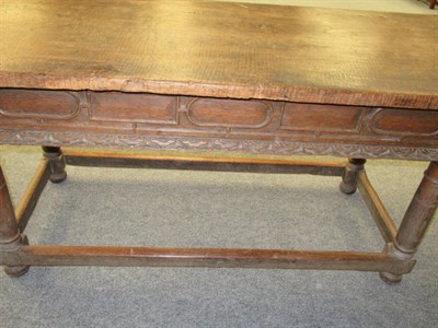 Lot 676 - A Mid 17th Century Refectory Table, the rectangular top above a frieze drawer carved with...